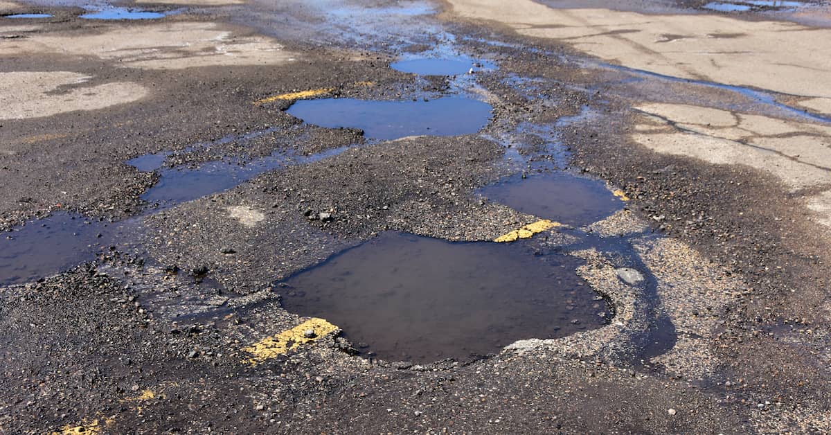 Pot holes in a parking lot. | Maggiano, DiGirolamo & Lizzi